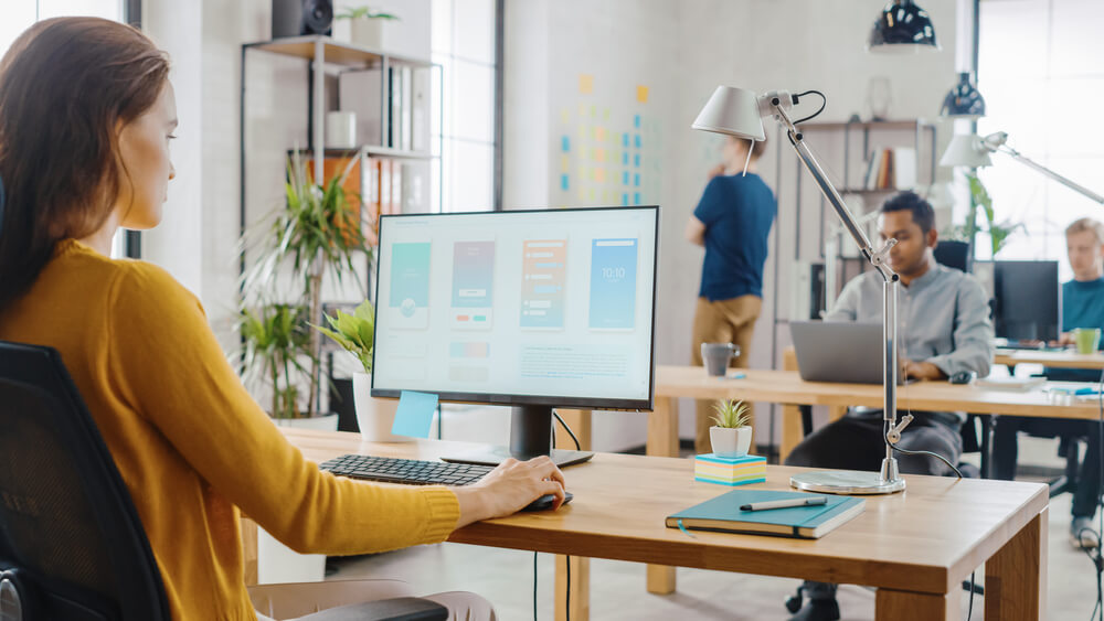 Web Designers North West England and the Way Businesses Use Their Websites Over Time Business website displayed on desktop and mobile devices in a North West England workplace.