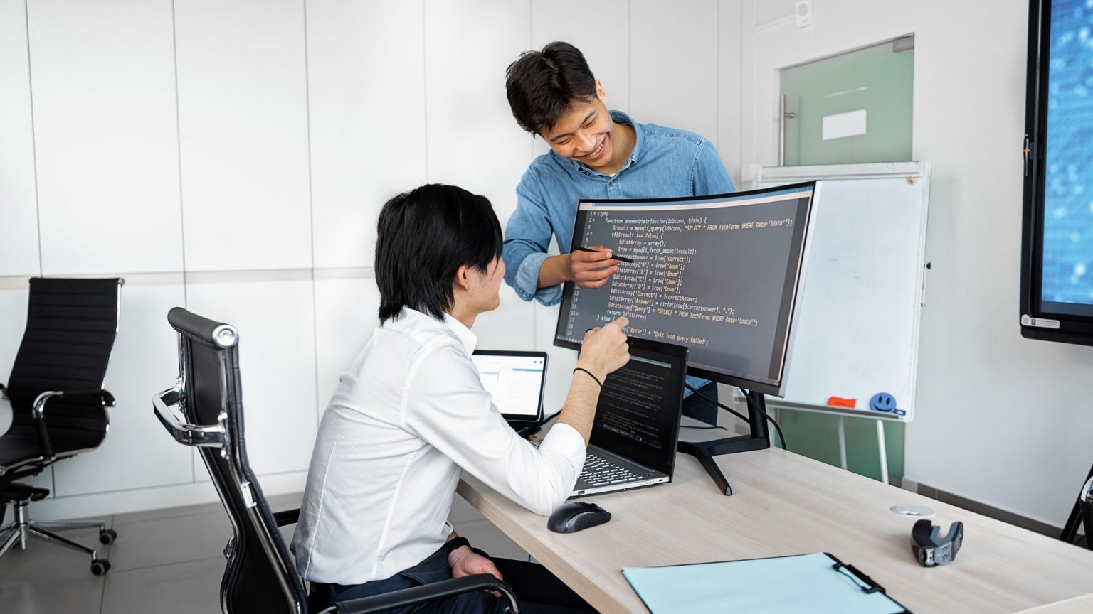 Engineers reviewing code on a monitor: Due Diligence on a Public-Record API: What Product Teams Should Establish First