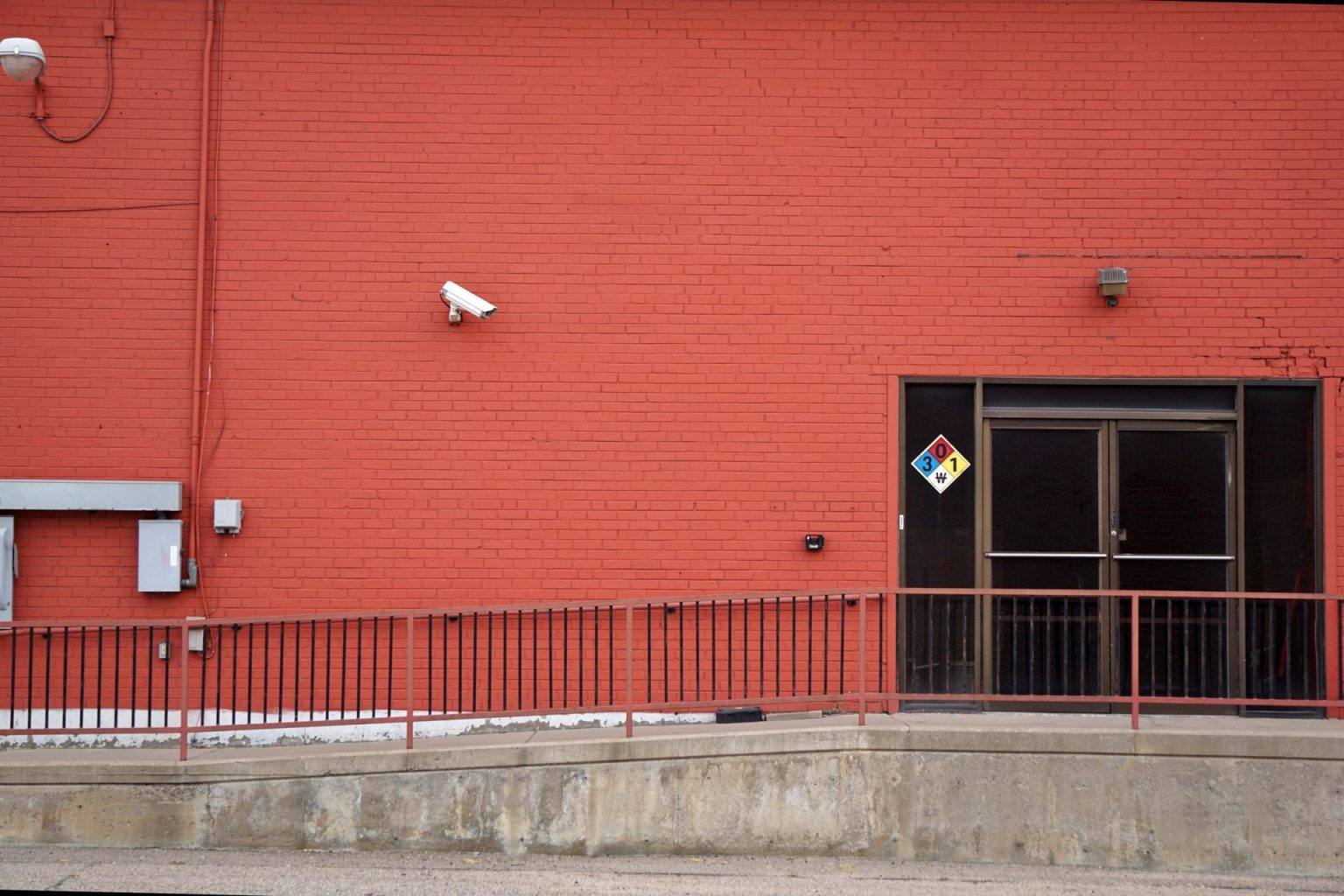 Just Under One in Three British Businesses Can Expect to Become Crime Victims This Year Security camera and rear entrance on a commercial building: Just Under One in Three British Businesses Can Expect to Become Crime Victims This Year