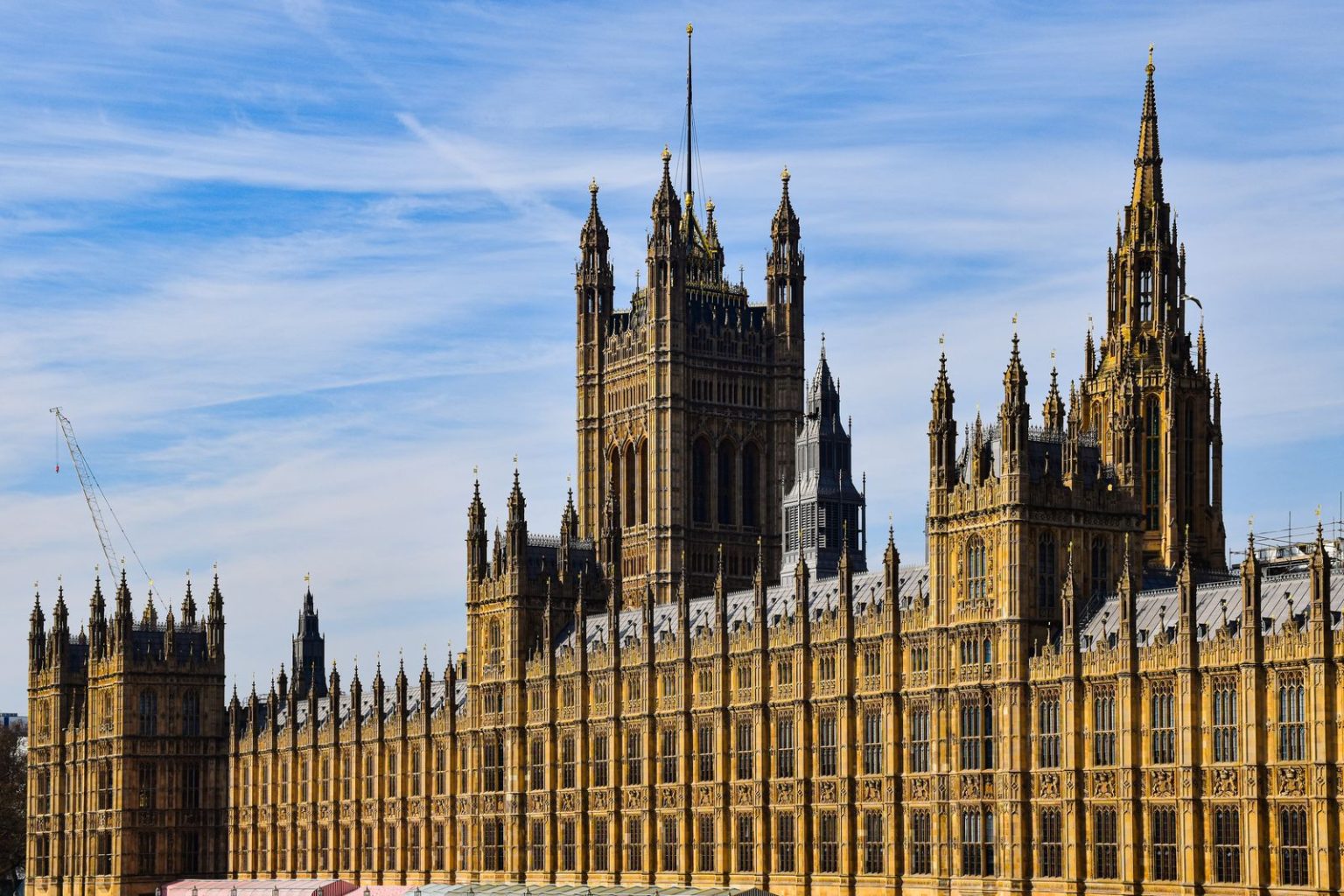 Home secretary orders urgent review of security for public figures after Widdecombe killing The Gothic stone towers and facade of the Palace of Westminster in London under a blue sky